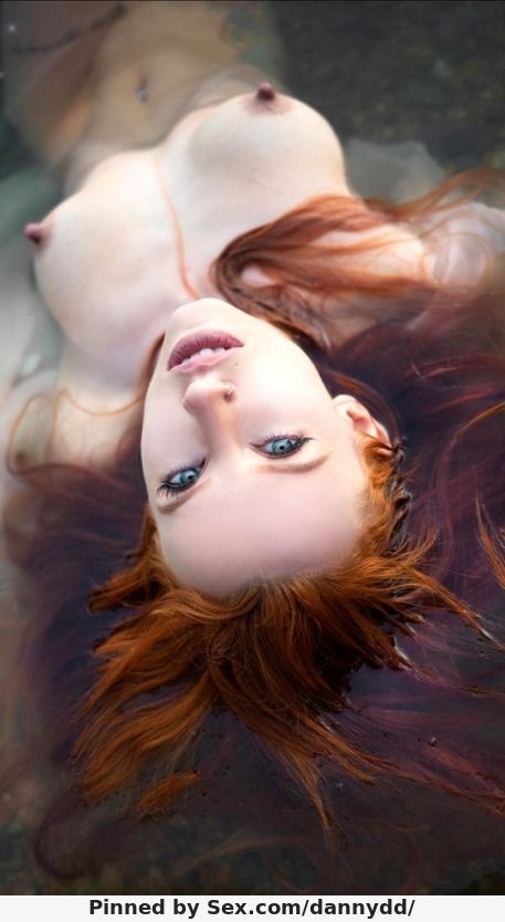 Beautiful redhead in pool