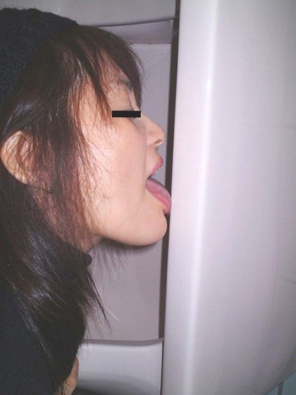 Asian cutie with tongue on urinal
